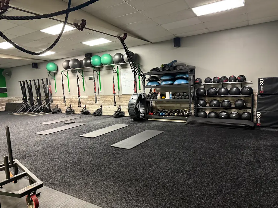 Mats laid out on the Legacy Fitness training floor, ready for the next class