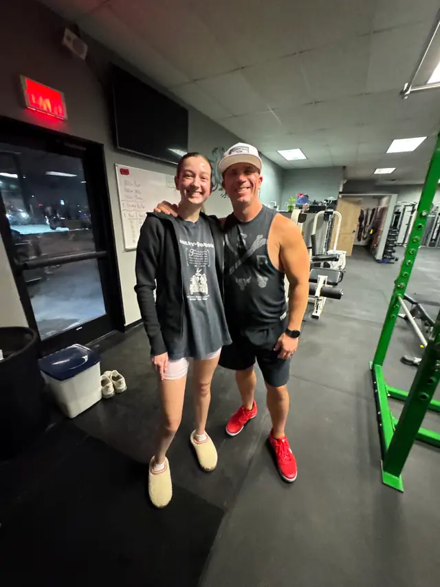 A member and a coach talking inside the Legacy Fitness gym
